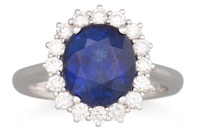 Lot 234 - A SAPPHIRE AND DIAMOND CLUSTER RING, the oval...