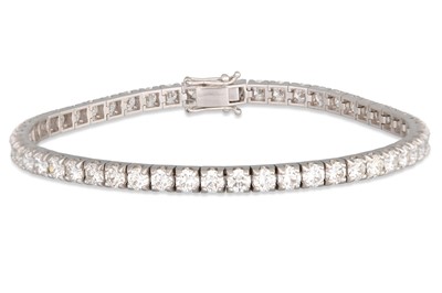 Lot 269 - A DIAMOND LINE BRACELET, the brilliant cut...