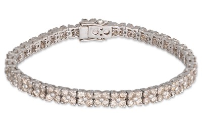 Lot 298 - A DIAMOND BRACELET, comprising clusters of...