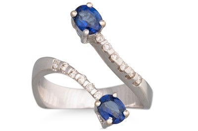 Lot 130 - A DIAMOND AND SAPPHIRE RING, of cross-over...