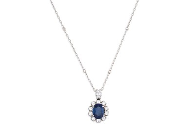Lot 132 - A DIAMOND AND SAPPHIRE CLUSTER PENDANT, the...