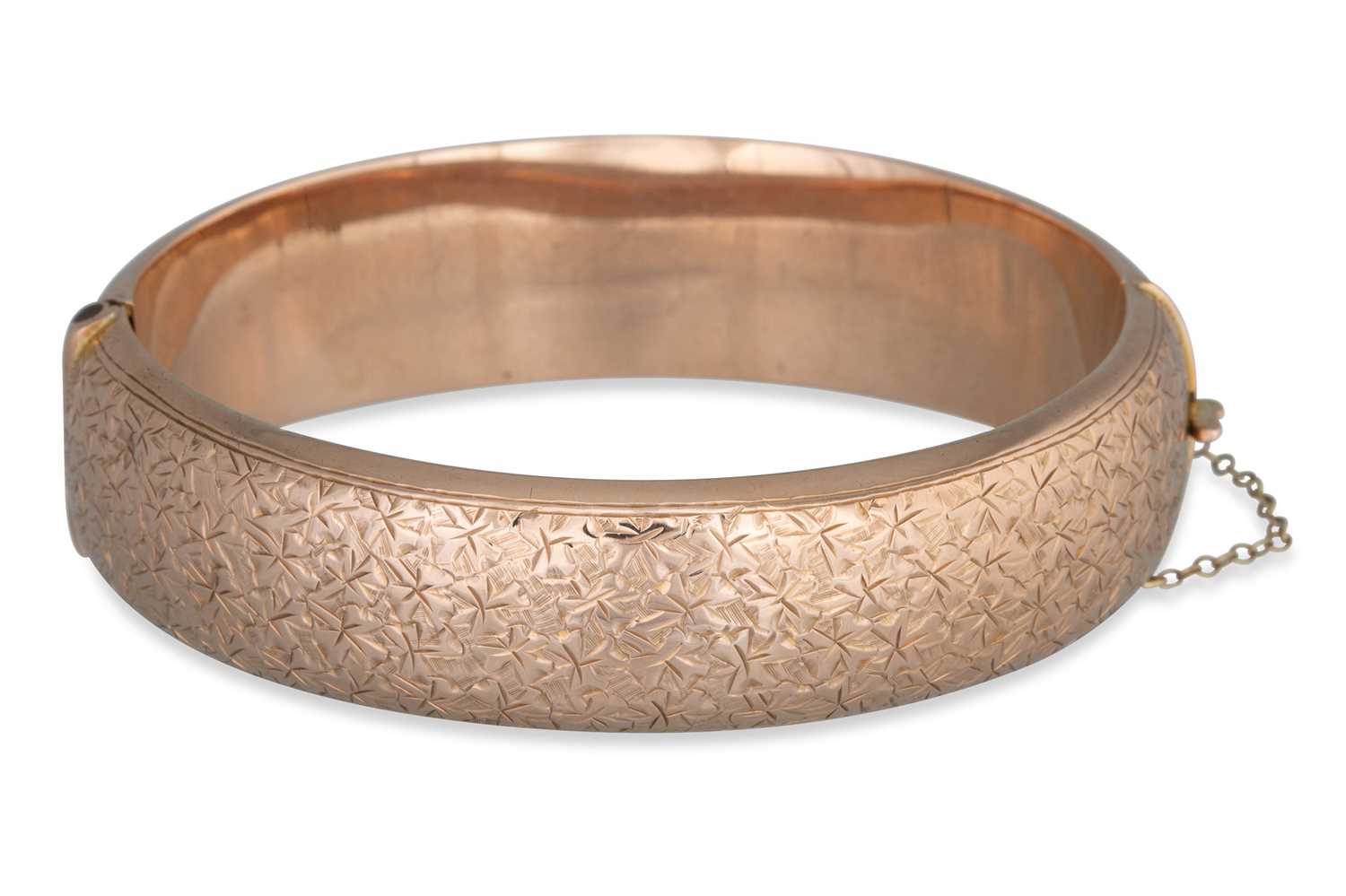 Lot 54 - A 9CT ROSE GOLD HOLLOW HINGED BANGLE, with...