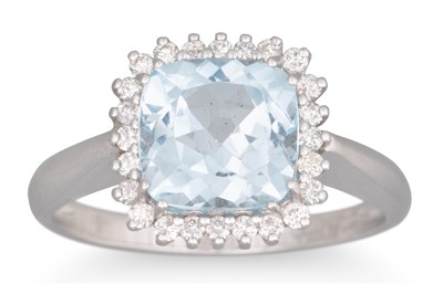 Lot 126 - A TOPAZ AND DIAMOND CLUSTER RING, the cushion...