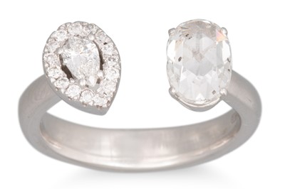 Lot 131 - A DIAMOND CROSS OVER RING, set with an oval...