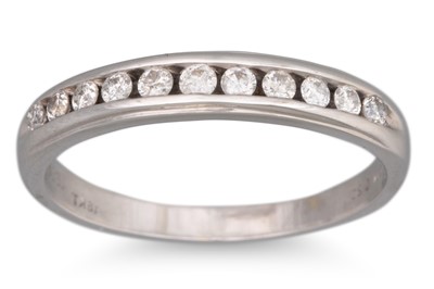 Lot 93 - A DIAMOND SET BAND RING, the channel set...