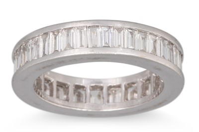 Lot 337 - A DIAMOND ETERNITY RING, channel set baguette...
