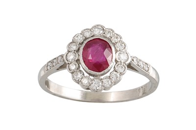 Lot 429 - A RUBY AND DIAMOND CLUSTER RING, the oval ruby...