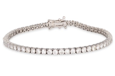 Lot 345 - A DIAMOND LINE BRACELET, the brilliant cut...