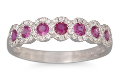 Lot 48 - A RUBY AND DIAMOND RING, the round rubies to...