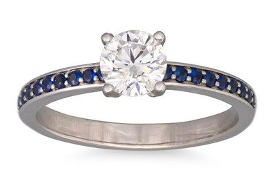 Lot 50 - A DIAMOND SOLITAIRE RING, to sapphire...