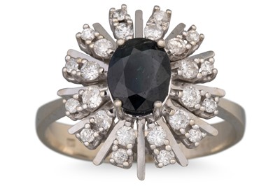 Lot 67 - A SAPPHIRE AND DIAMOND CLUSTER RING, the oval...