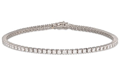 Lot 227 - A DIAMOND LINE BRACELET, the brilliant cut...