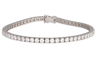 Lot 246 - A DIAMOND LINE BRACELET, the brilliant cut...