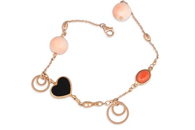 Lot 154 - A PINK CORAL AND ONYX BRACELET, mounted in...