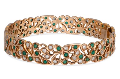Lot 275 - A YELLOW GOLD HINGED BANGLE, floral decoration,...