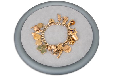 Lot 321 - A 9CT GOLD CHARM BRACELET, with charms...