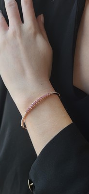 Lot 73 - A PINK SAPPHIRE AND DIAMOND SET BANGLE,...