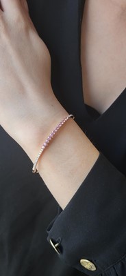 Lot 73 - A PINK SAPPHIRE AND DIAMOND SET BANGLE,...