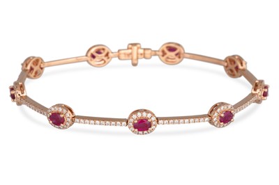 Lot 225 - A RUBY AND DIAMOND BRACELET, comprising oval...