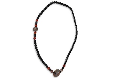 Lot 28 - A LONG BEADED NECKLACE, most likely varieties...
