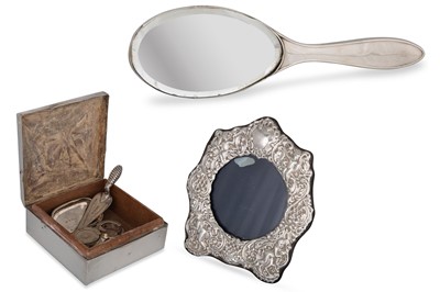 Lot 493 - A SHAPED CIRCULAR SILVER EMBOSSED PHOTO FRAME,...
