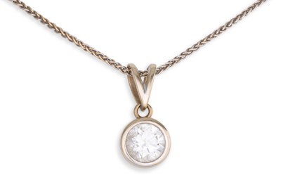 Lot 385 - A DIAMOND SOLITAIRE PENDANT, the round...