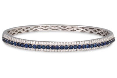 Lot 199 - A DIAMOND AND SAPPHIRE THREE ROWED BANGLE,...