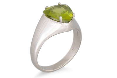 Lot 155 - A PERIDOT RING, the triangular peridot mounted...