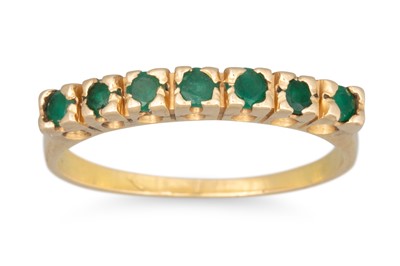 Lot 235 - A SEVEN STONE EMERALD RING, mounted in 18ct...