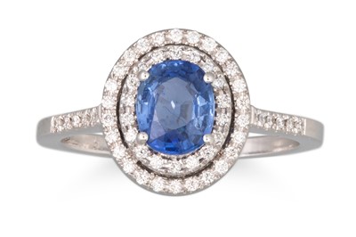 Lot 297 - A SAPPHIRE AND DIAMOND RING, the oval sapphire...