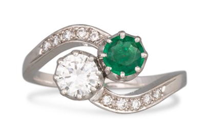 Lot 174 - AN EMERALD AND DIAMOND 'TOI ET MOI' RING,...