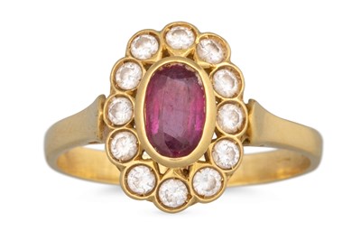 Lot 28 - A DIAMOND AND RUBY CLUSTER RING, the oval ruby...