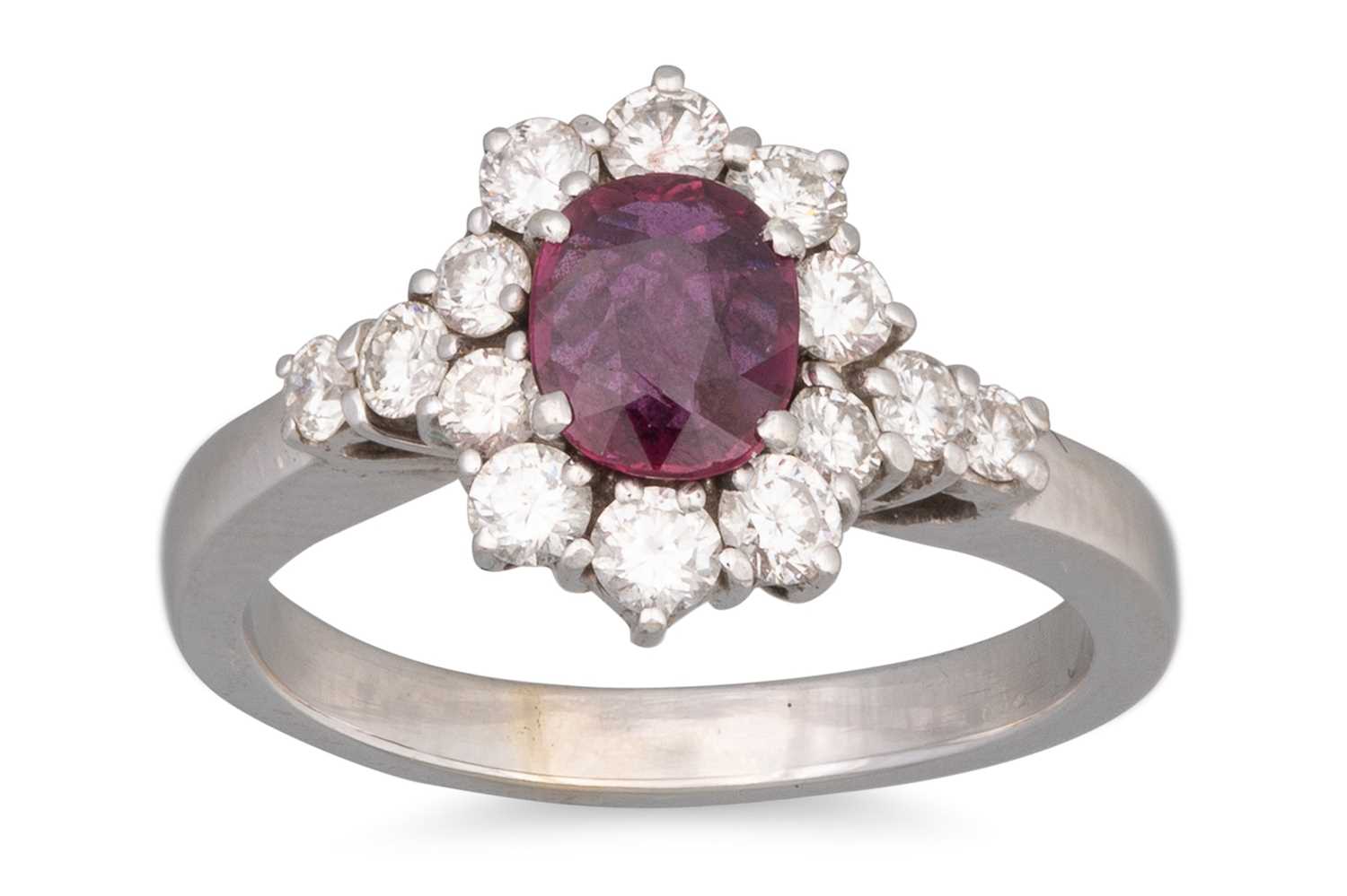 Lot 51 - A DIAMOND AND RUBY CLUSTER RING, oval ruby to...