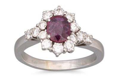 Lot 51 - A DIAMOND AND RUBY CLUSTER RING, oval ruby to...