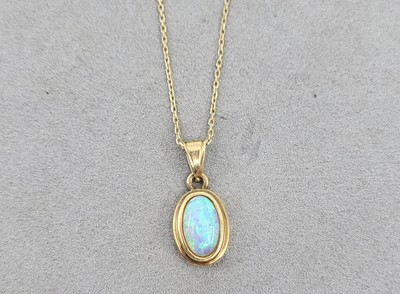 Lot 59 - A 14CT GOLD AND SYNTHETIC OPAL PENDANT, with...