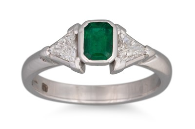 Lot 49 - AN EMERALD AND DIAMOND THREE STONE RING, the...