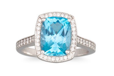 Lot 235 - A TOPAZ AND DIAMOND CLUSTER RING, mounted in...