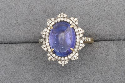 Lot 72 - A CABOCHON TANZANITE AND DIAMOND CLUSTER RING,...