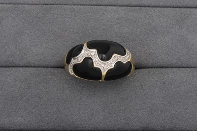 Lot 63 - AN ONYX AND DIAMOND BOMBE RING, mounted in...