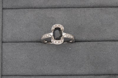 Lot 68 - A SAPPHIRE AND DIAMOND CLUSTER RING, mounted...