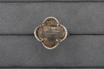 Lot 70 - A SMOKEY QUARTZ AND DIAMOND CLUSTER RING,...