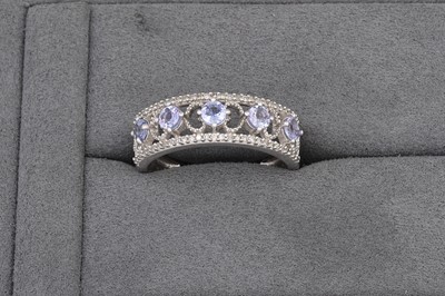 Lot 71 - A TANZANITE AND DIAMOND BAND RING, mounted in...