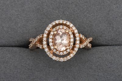 Lot 98 - A MORGANITE AND DIAMOND HALO CLUSTER RING,...