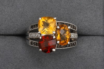 Lot 109 - A THREE ROWED GARNET, CITRINE AND DIAMOND RING,...