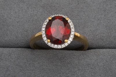 Lot 95 - A GARNET AND DIAMOND CLUSTER RING, mounted in...