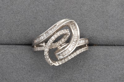 Lot 103 - A CROSS - OVER DIAMOND SET RING, set with...