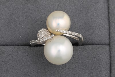 Lot 107 - A PEARL AND DIAMOND RING, the two white pearls...