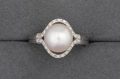 Lot 112 - A PEARL AND DIAMOND CLUSTER RING, mounted in...