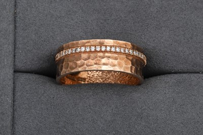Lot 114 - A DIAMOND SET BAND RING, mounted in 9ct yellow...