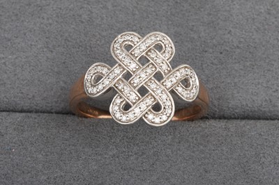 Lot 117 - A DIAMOND SET CELTIC STYLE RING, mounted in...